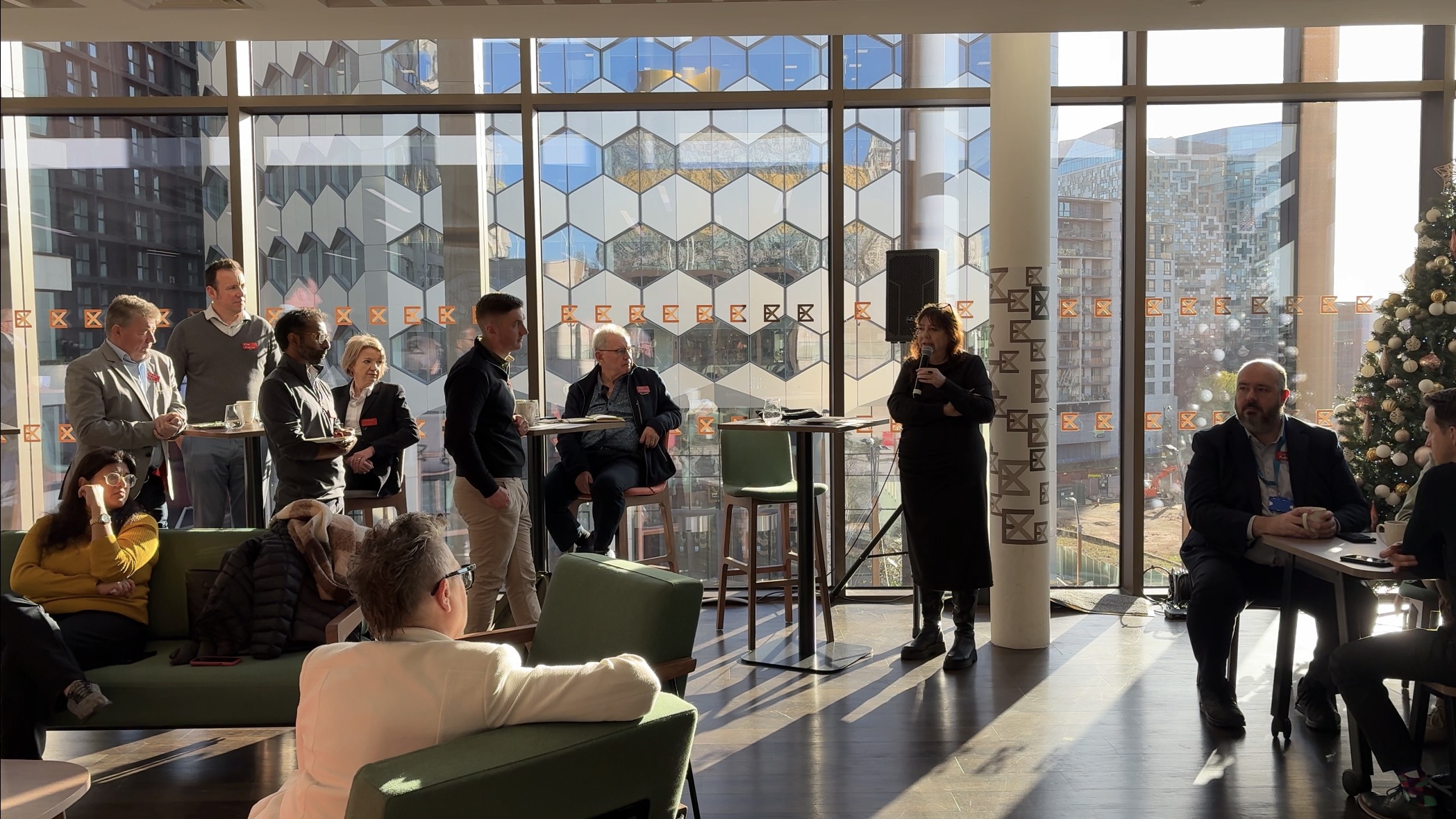 Guests listen to speakers in reception at The Exchange