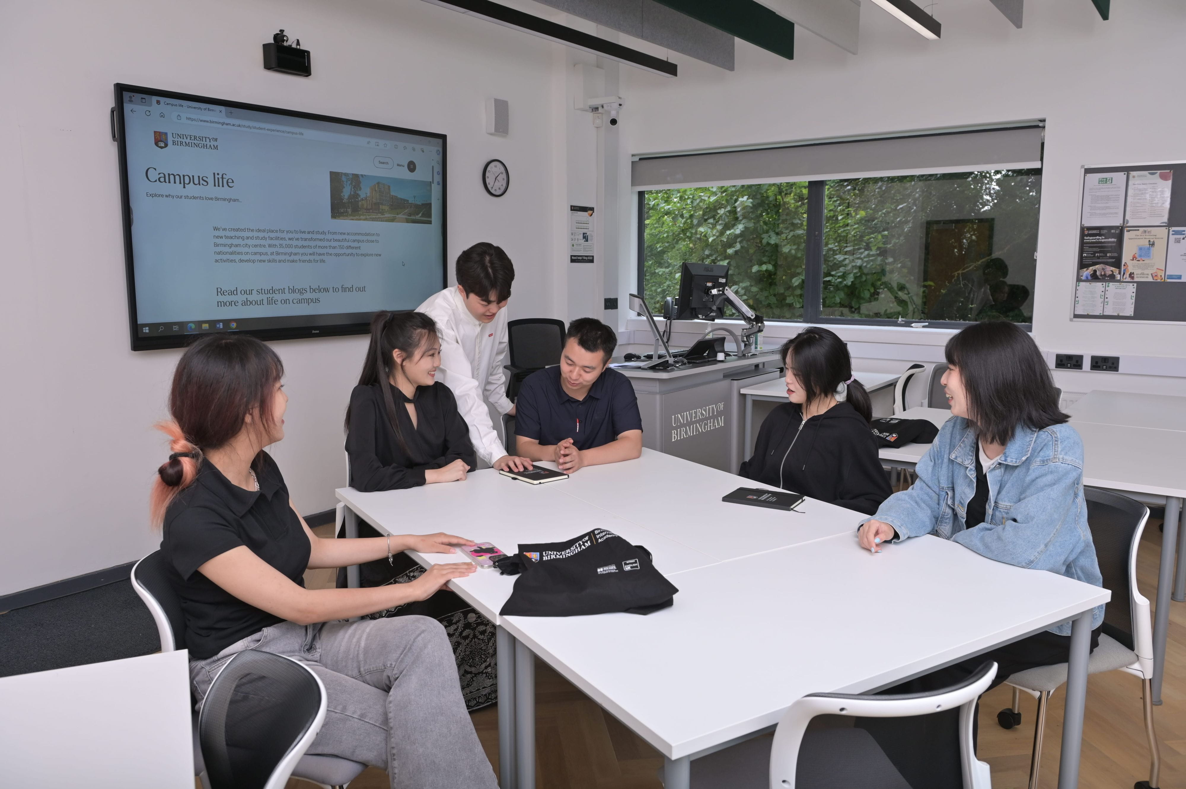 International students talking and working together in a classroom.