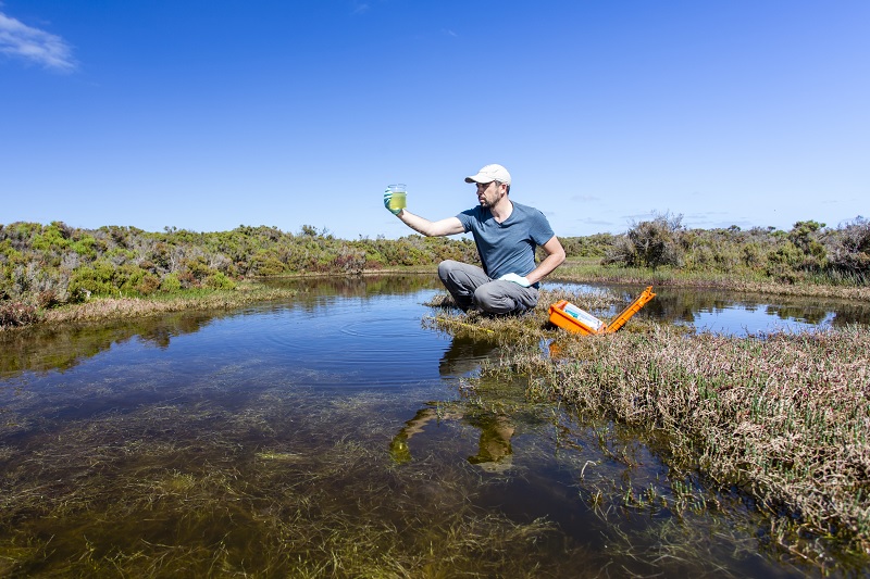 man testing water purity in a wilderness 