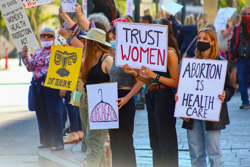 Women holding placards protesting for legal abortion
