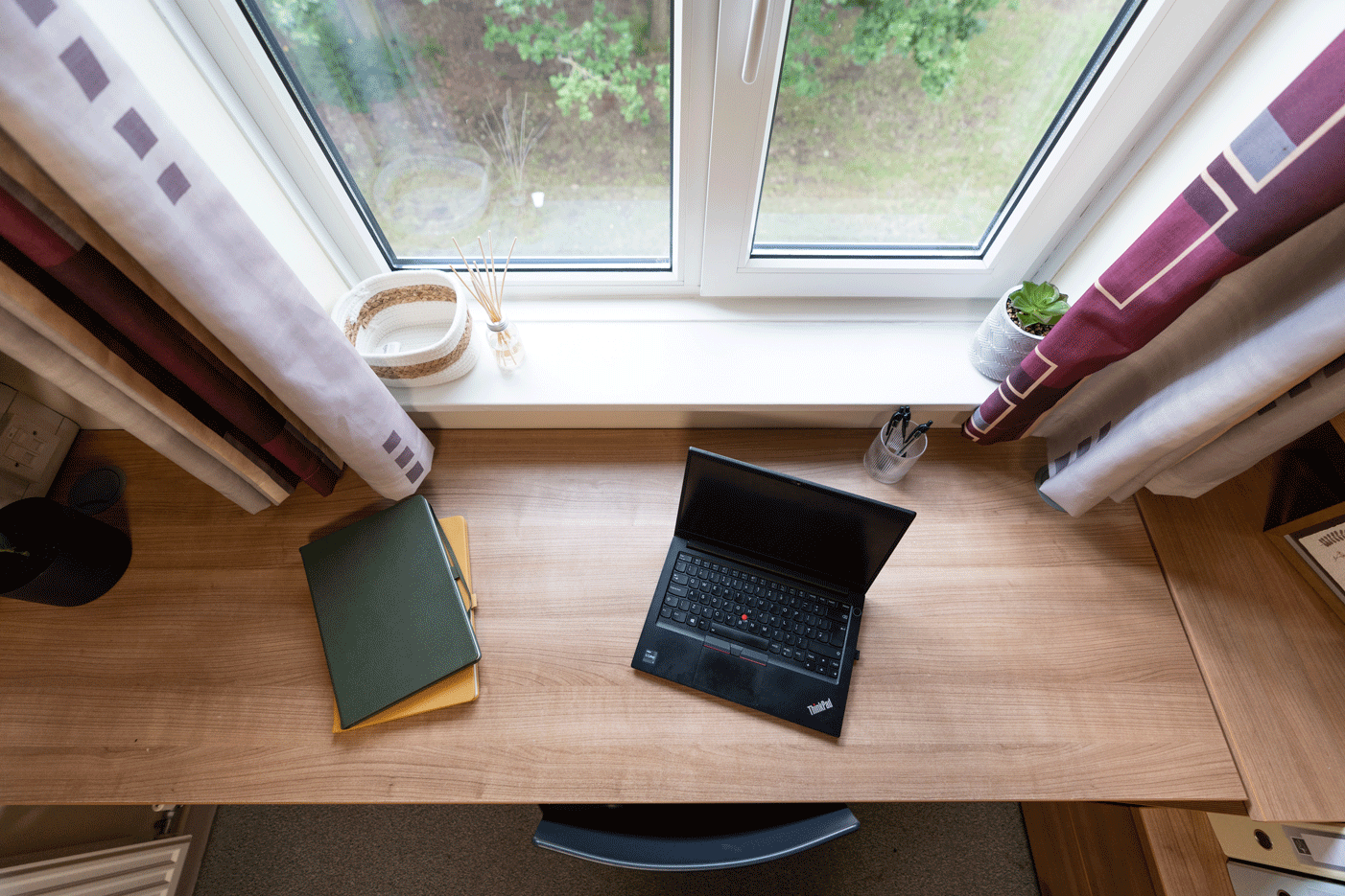 Desk with some books and laptop on it