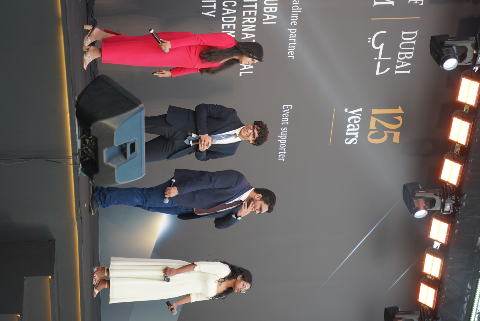 Andrew and other speakers on an outdoor stage at the University's 125 celebration. 
