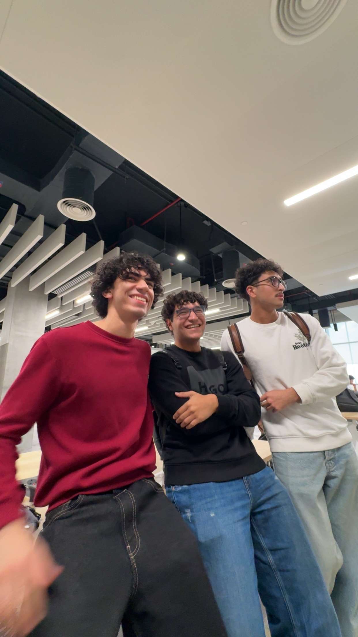 Andrew stood smiling with two friends.