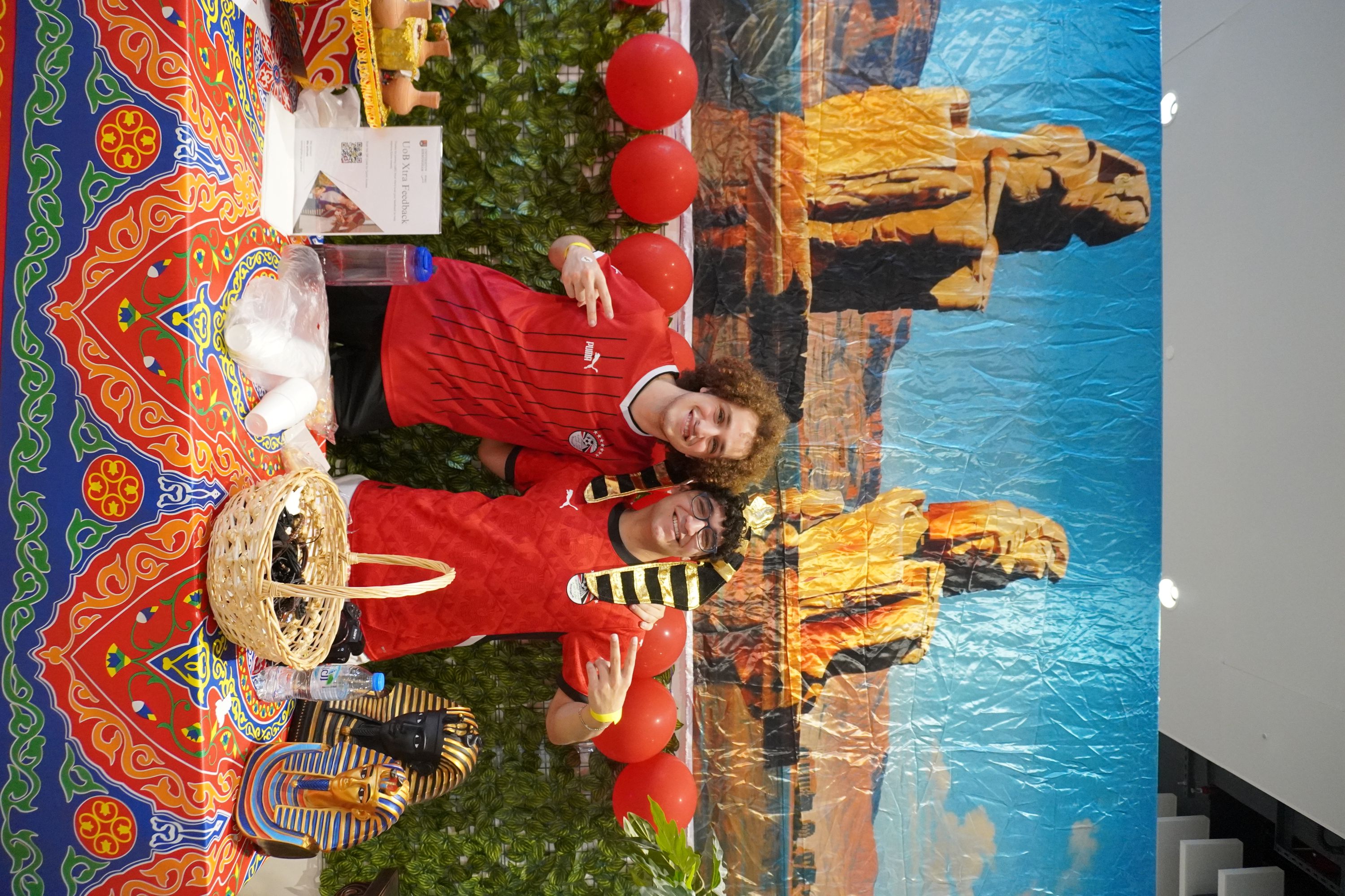 Andrew and another student in a colourful Egyptian cultural display booth for Global Day.