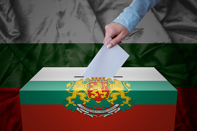 Person posting their vote in a ballot box in Bulgaria