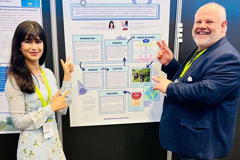 Centre Director Prof Andrew Davies and Associate Director Dr Maryyum Mehmood in front of a research poster