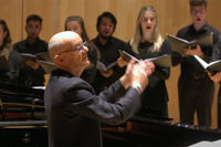 Bob Chilcott conducting singers in a choir