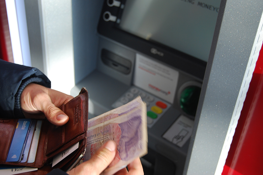Money being taken out of a cashpoint machine