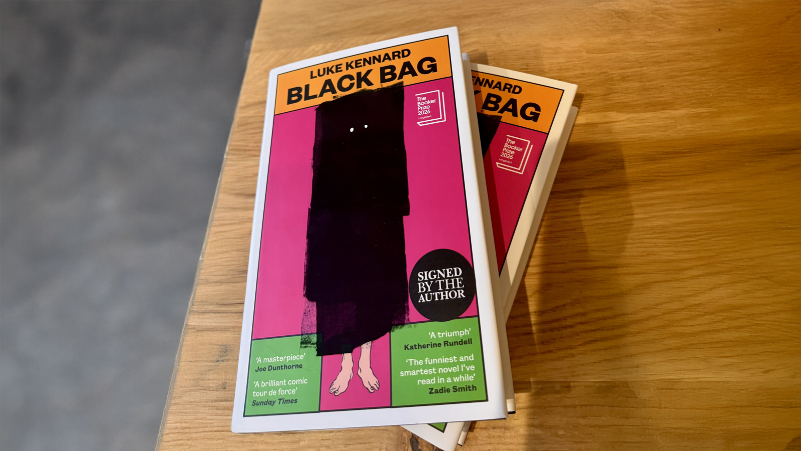 Two copies of Luke Kennard's Black Bag on a table