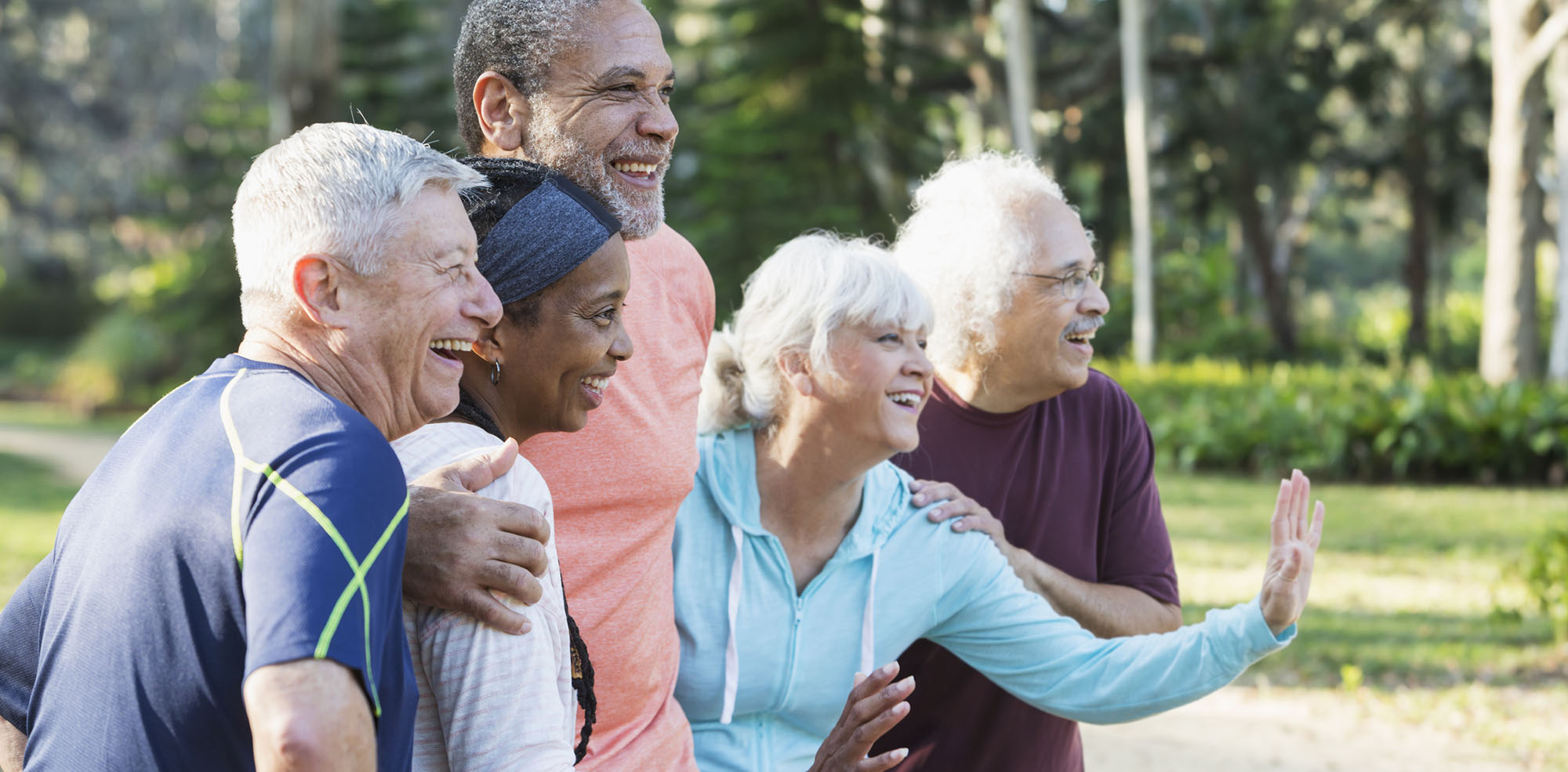 A diverse group of happy senior people outside together