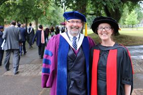 Diana Spencer and fellow academic in graduation robes outdoors
