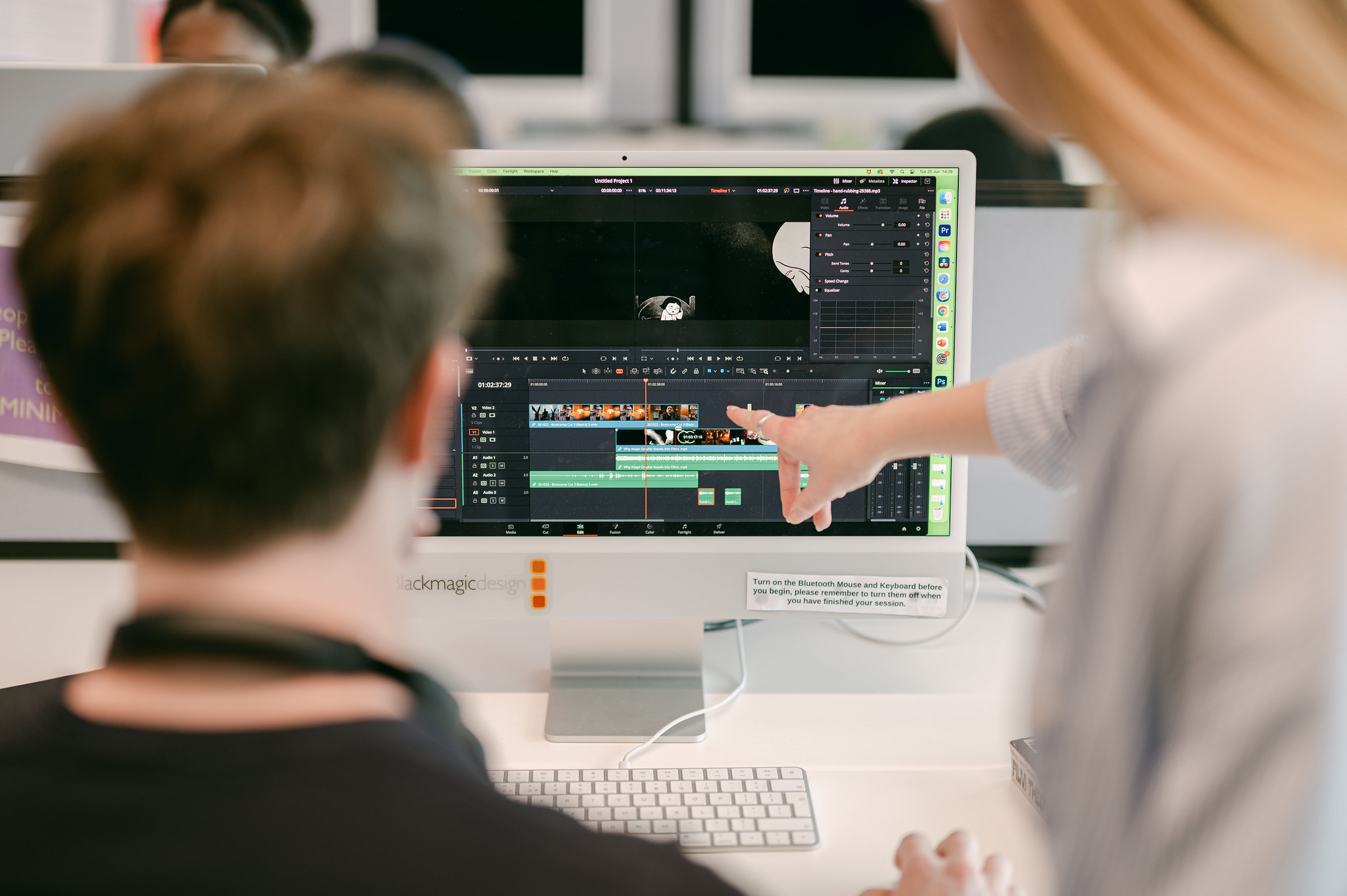 Students editing a film on a computer