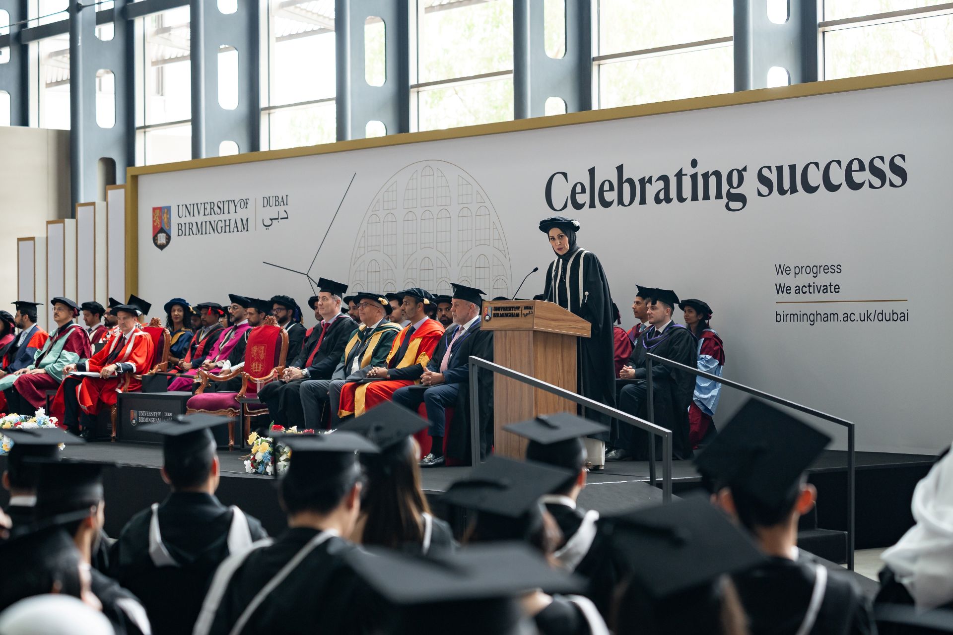 Dubai Provost Professor Yusra Mouzughi addressing graduates during a University of Birmingham Dubai graduation ceremony.