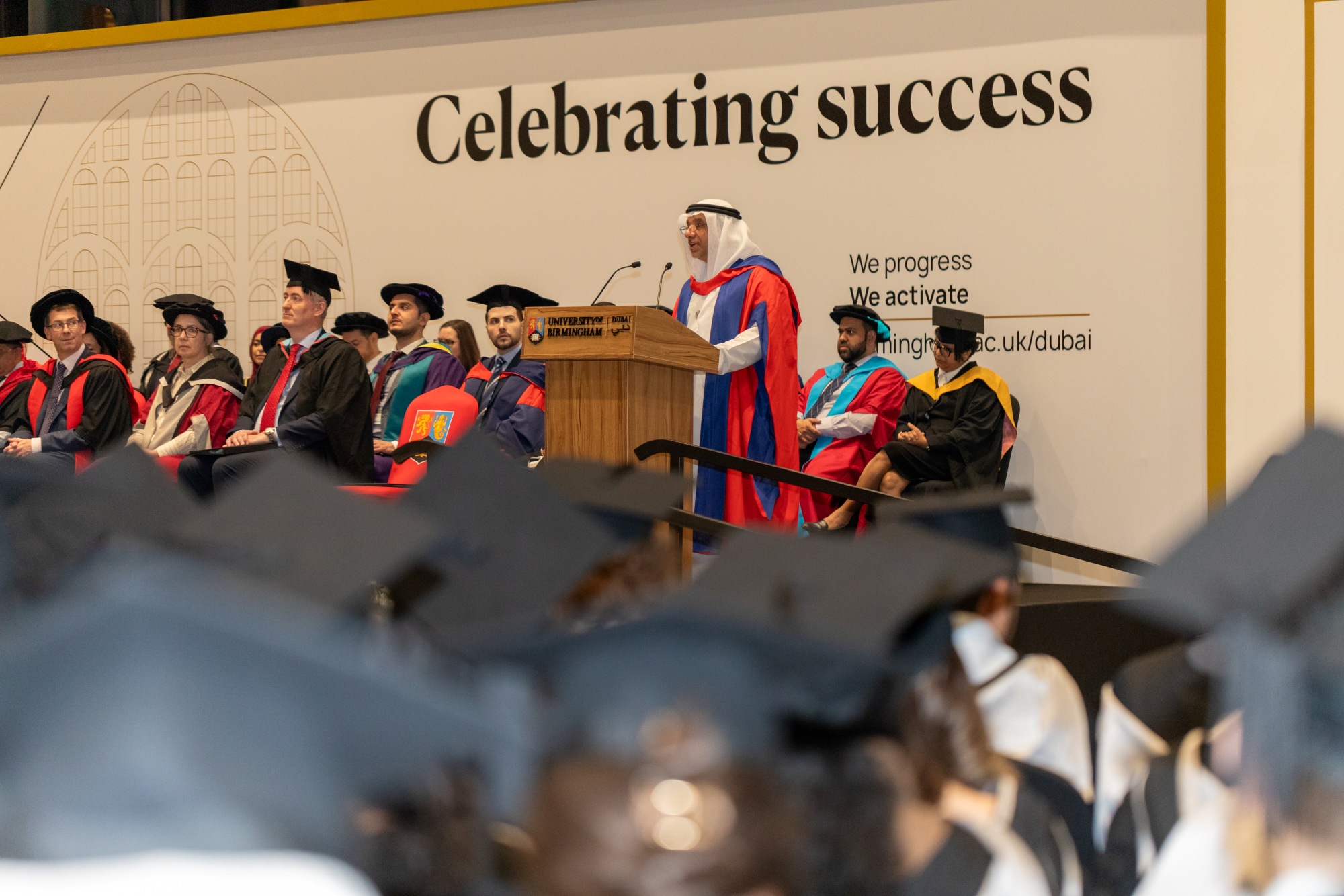 Professor Dr Mohamed Yousif Baniyas speaking at a lecturn on stage at his honorary graduation.