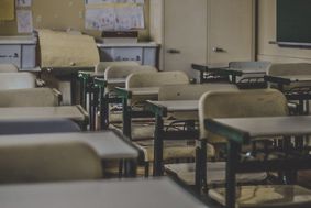 rows of desks in an empty classroom