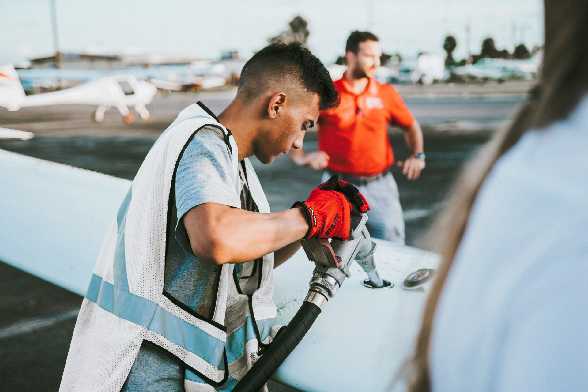 A technician refuelling a light aircraft