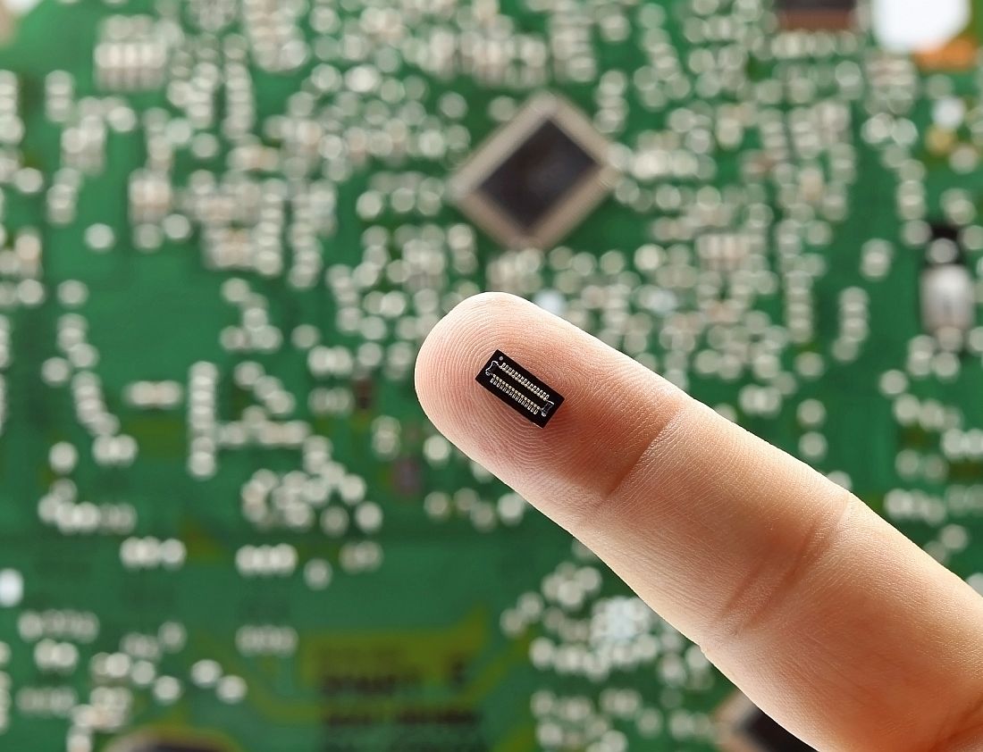 A finger showing an electronic component