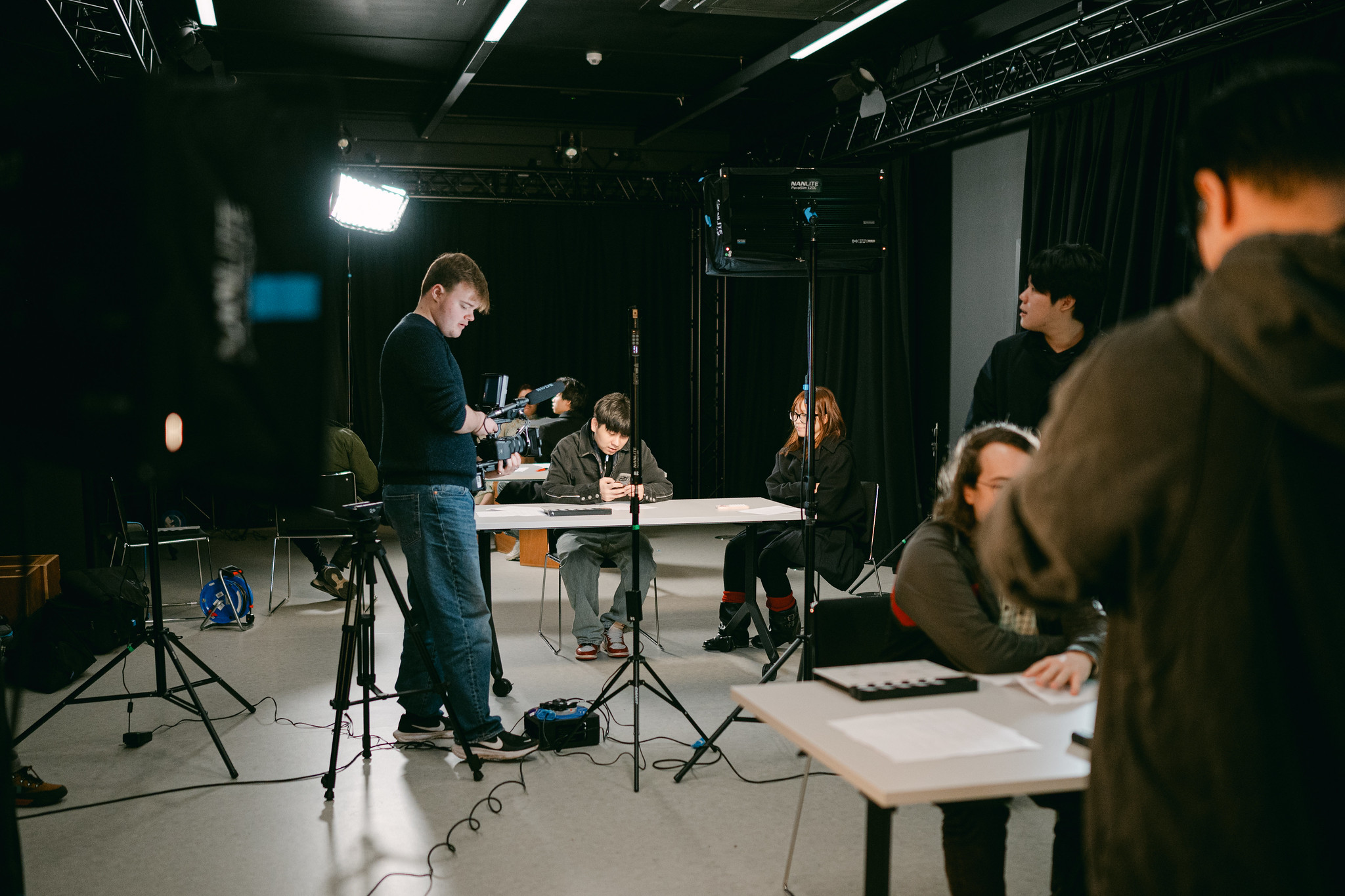 Students filming in content creation studio