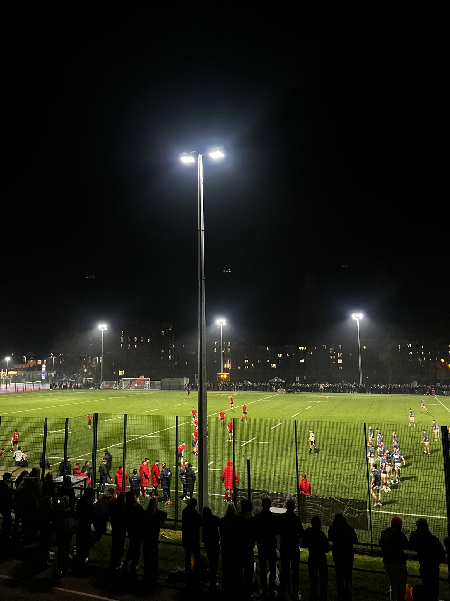 Sports teams playing on pitches late at night