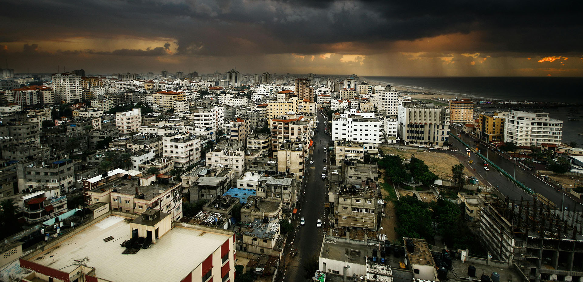 An aerial view of Gaza at night during a rainstorm with a dramatic skyline