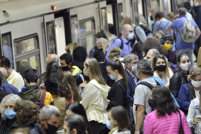 Subway train passengers wearing face masks crowding to get on and off the train