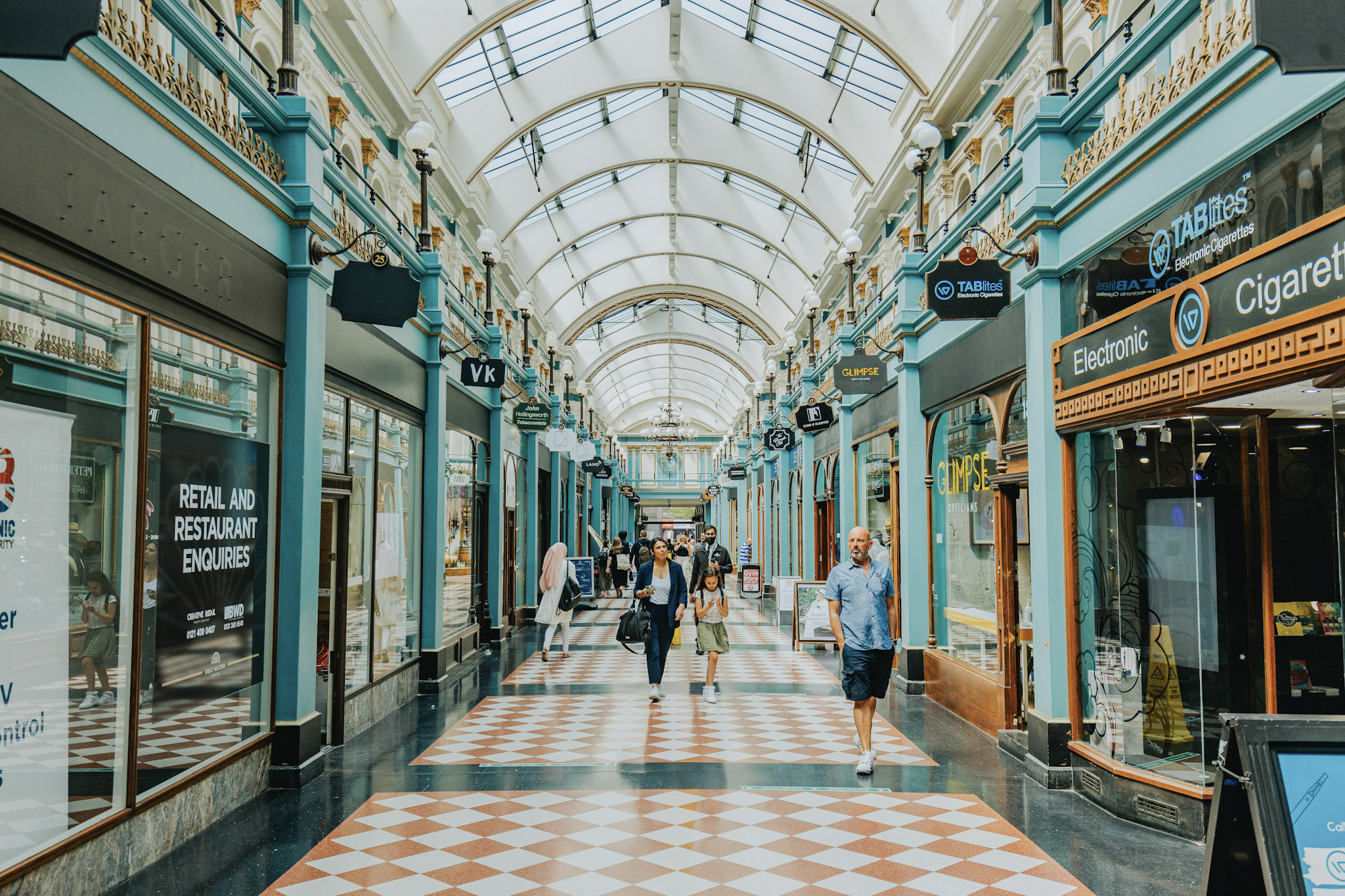 People walking down an arcade