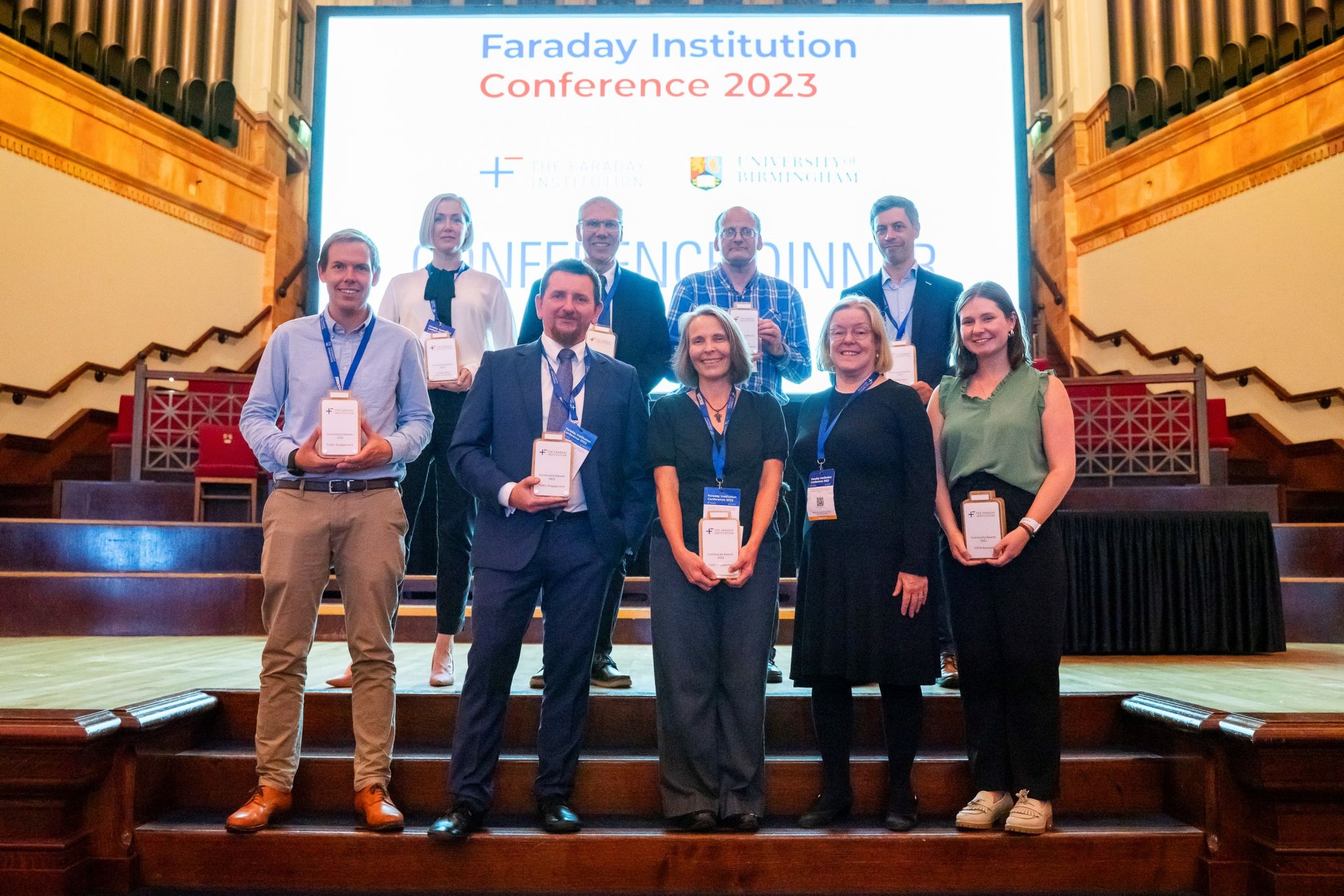 Peter Slater stands on stage with the other award winners 