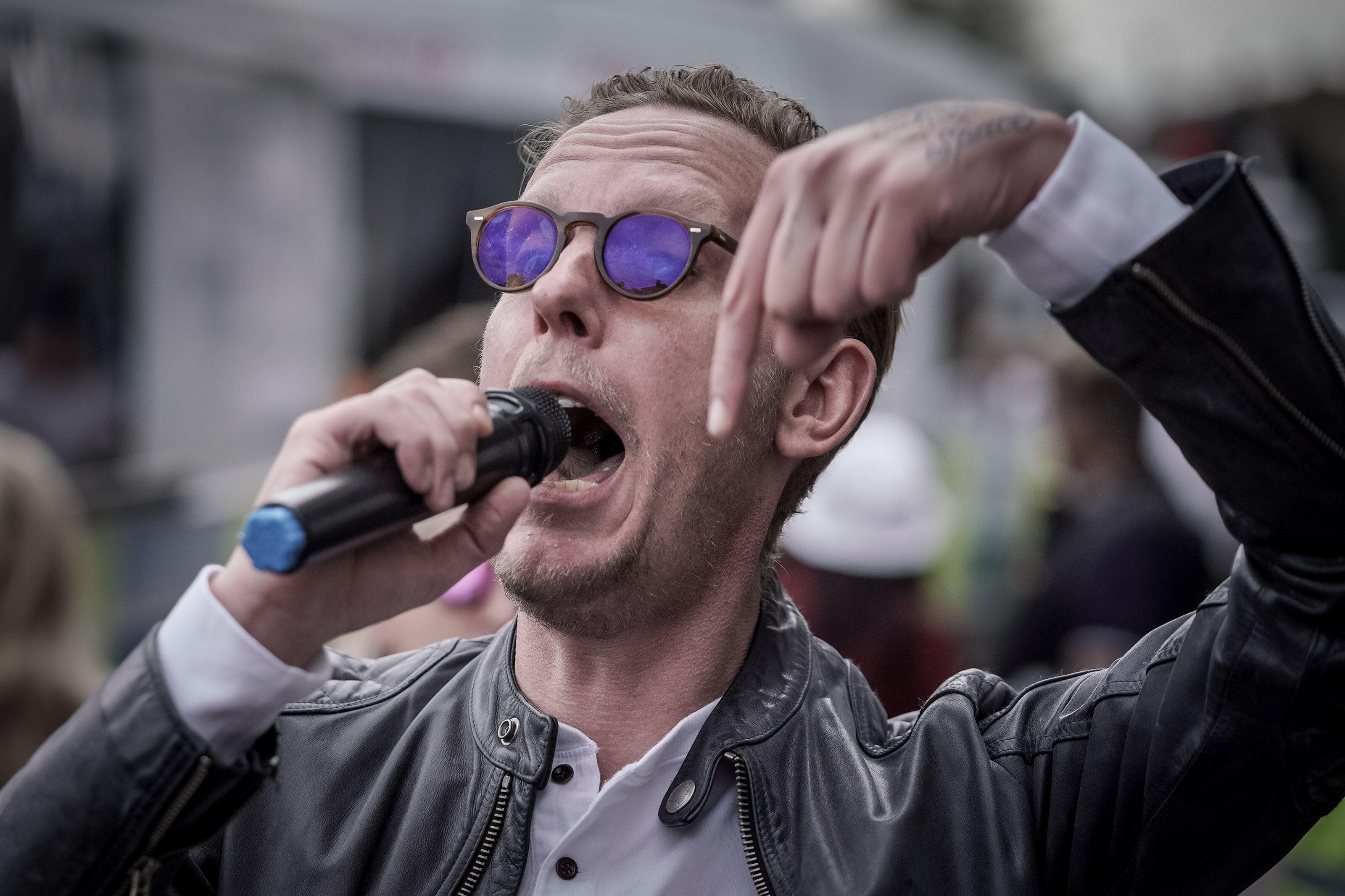 Right-wing activist and former actor Laurence Fox speaking into a microphone at a rally