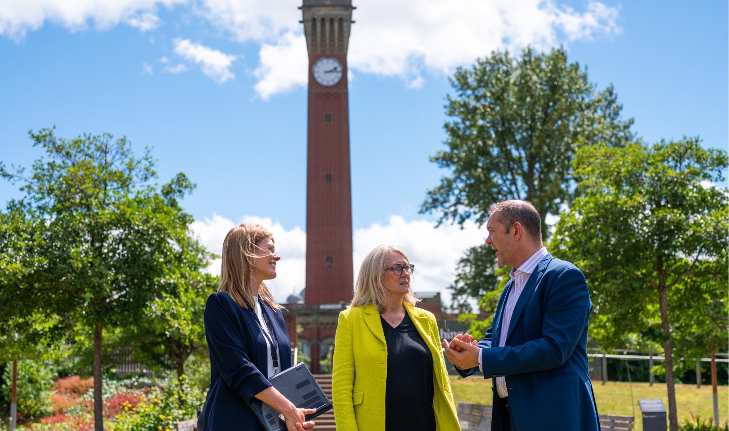 Professor Deborah Longworth, Baroness Smith and Jon Elsmore stood in front of the Old Joe clock tower.