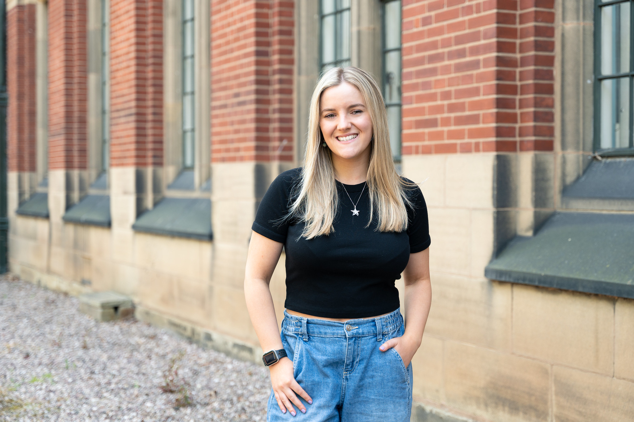 Student Chloe stands on the University of Birmingham Campus