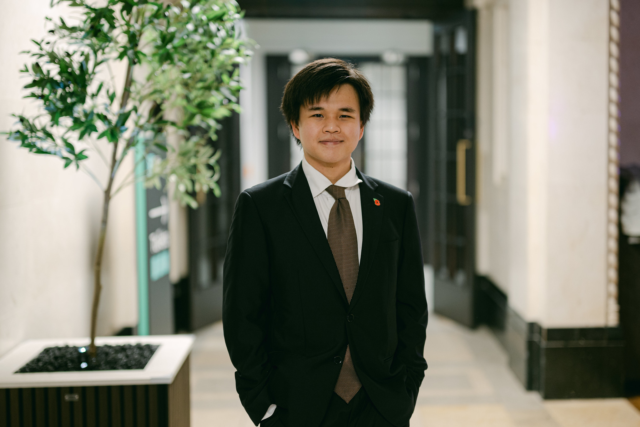 Keith Phoon wears a suit and smiles at the camera.