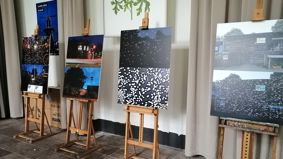 four air pollution images displayed on easels