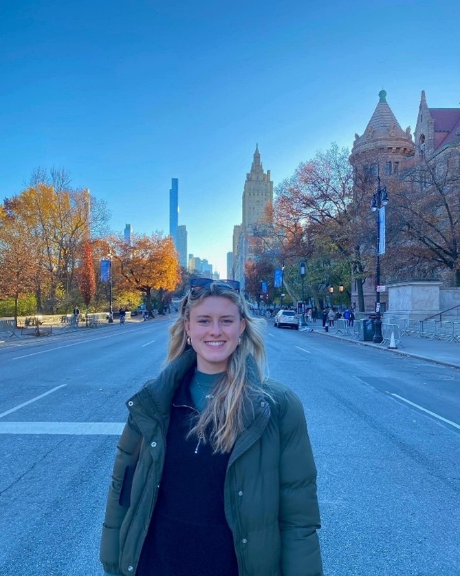 Alexandra standing on a street standing looking at the camera