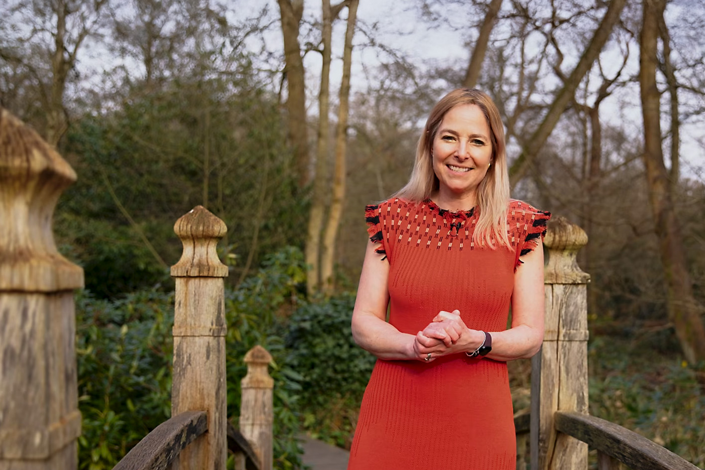 Alice Roberts standing on an ornate bridge