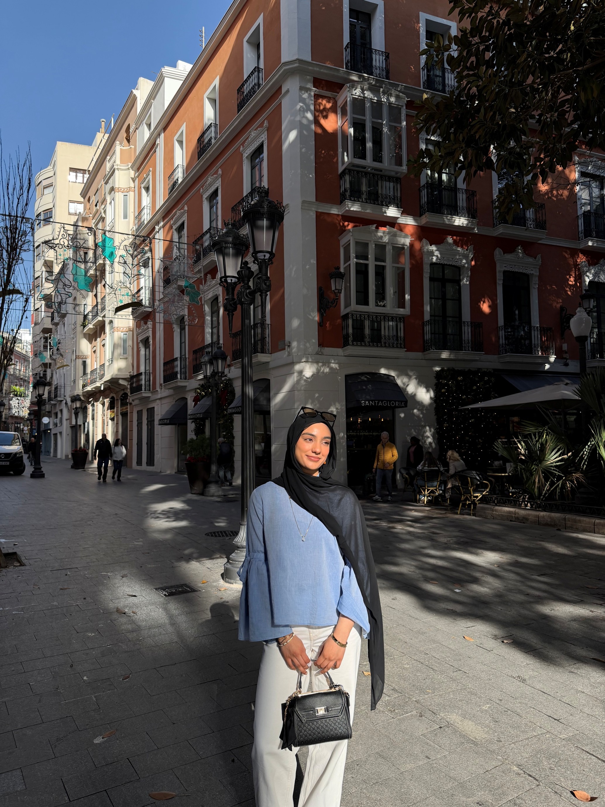 Student Alina standing in the street holding her bag.