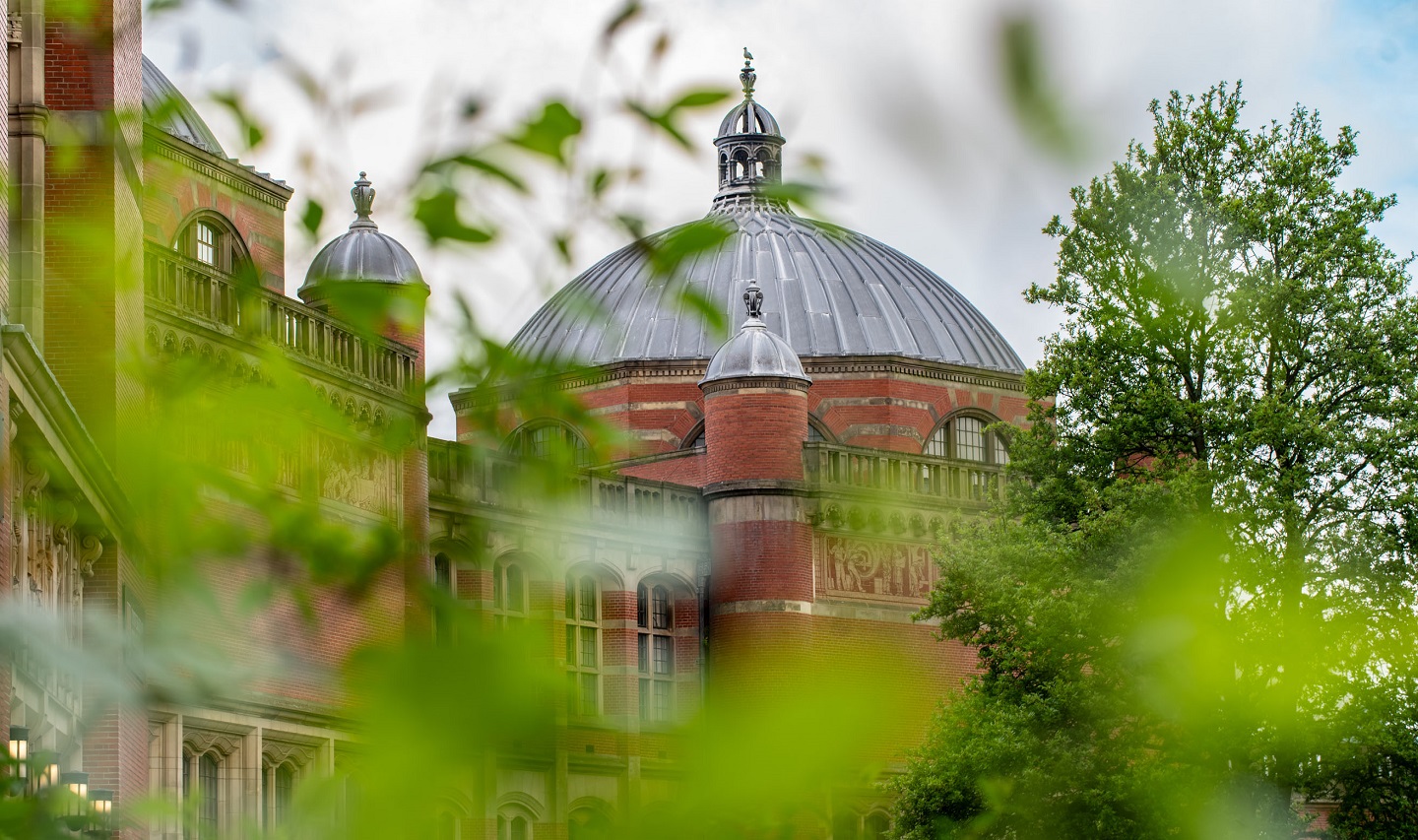 Photo of Aston Webb through bushes