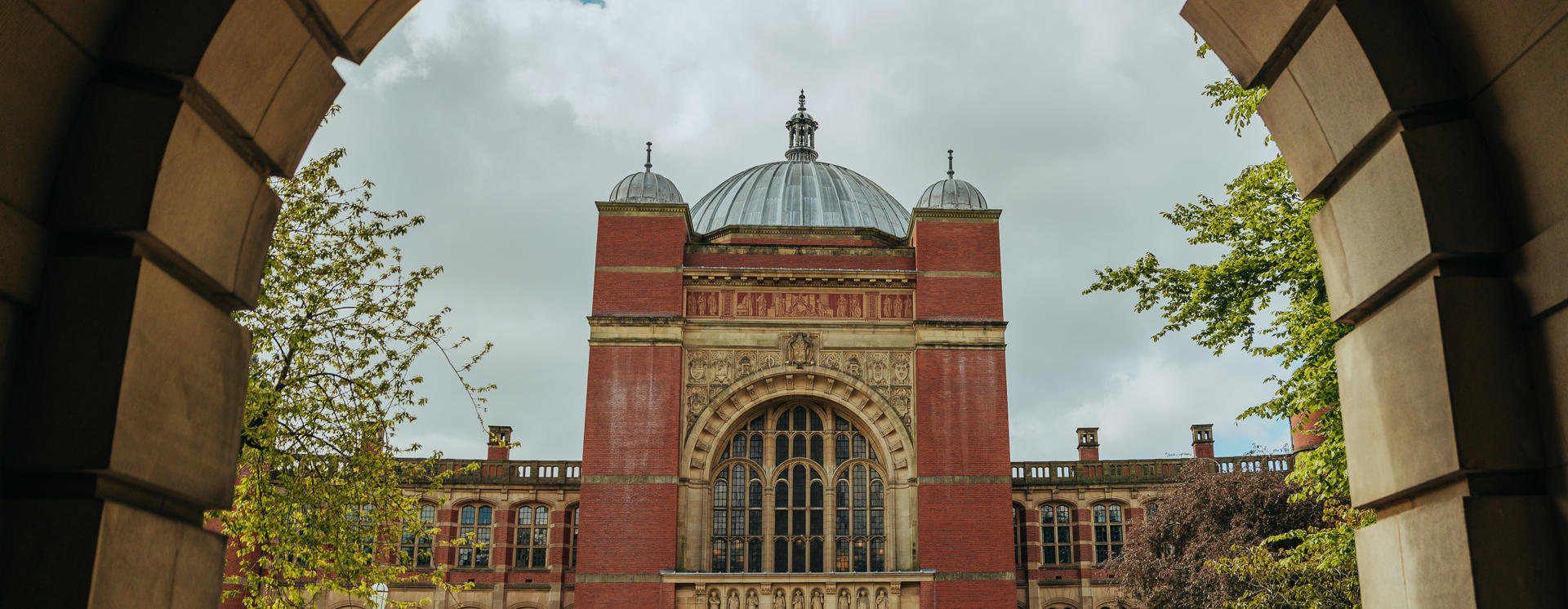 Image of Aston Webb Building taken through the arch of the University's law building  