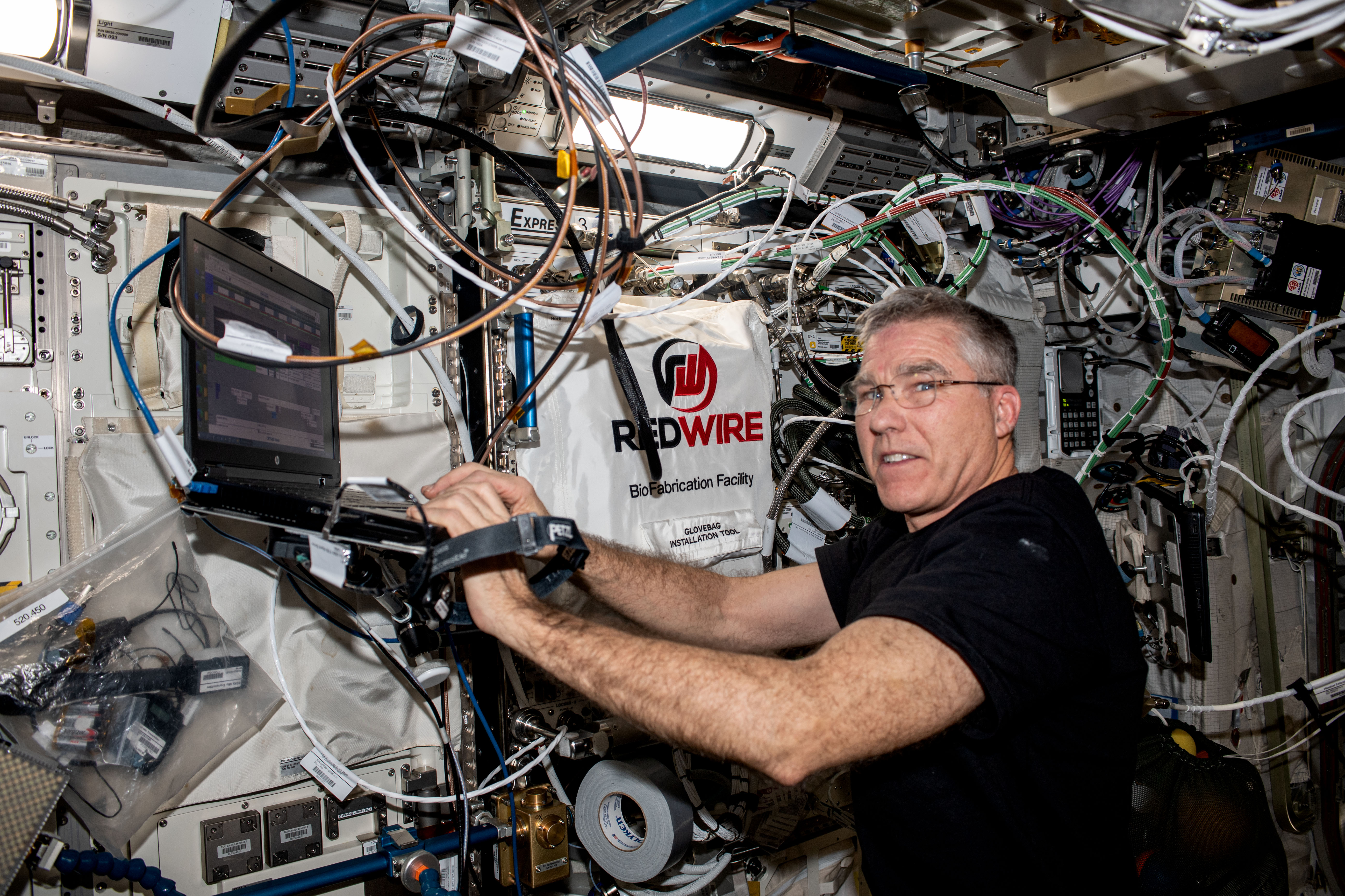 Astronaut operating equipment aboard the ISS