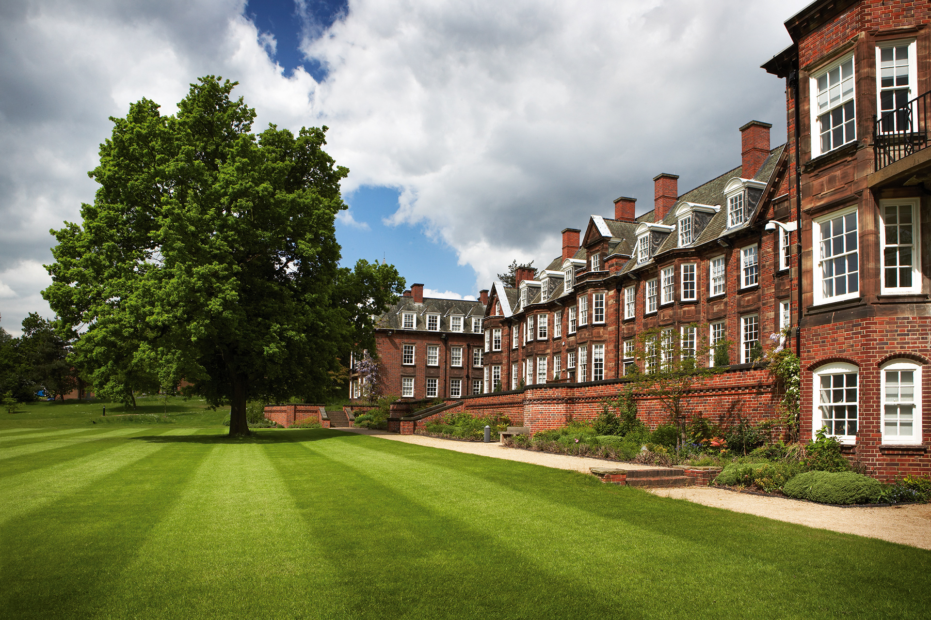 The red brick building of Birmingham Business School with its perfectly manicured lawn