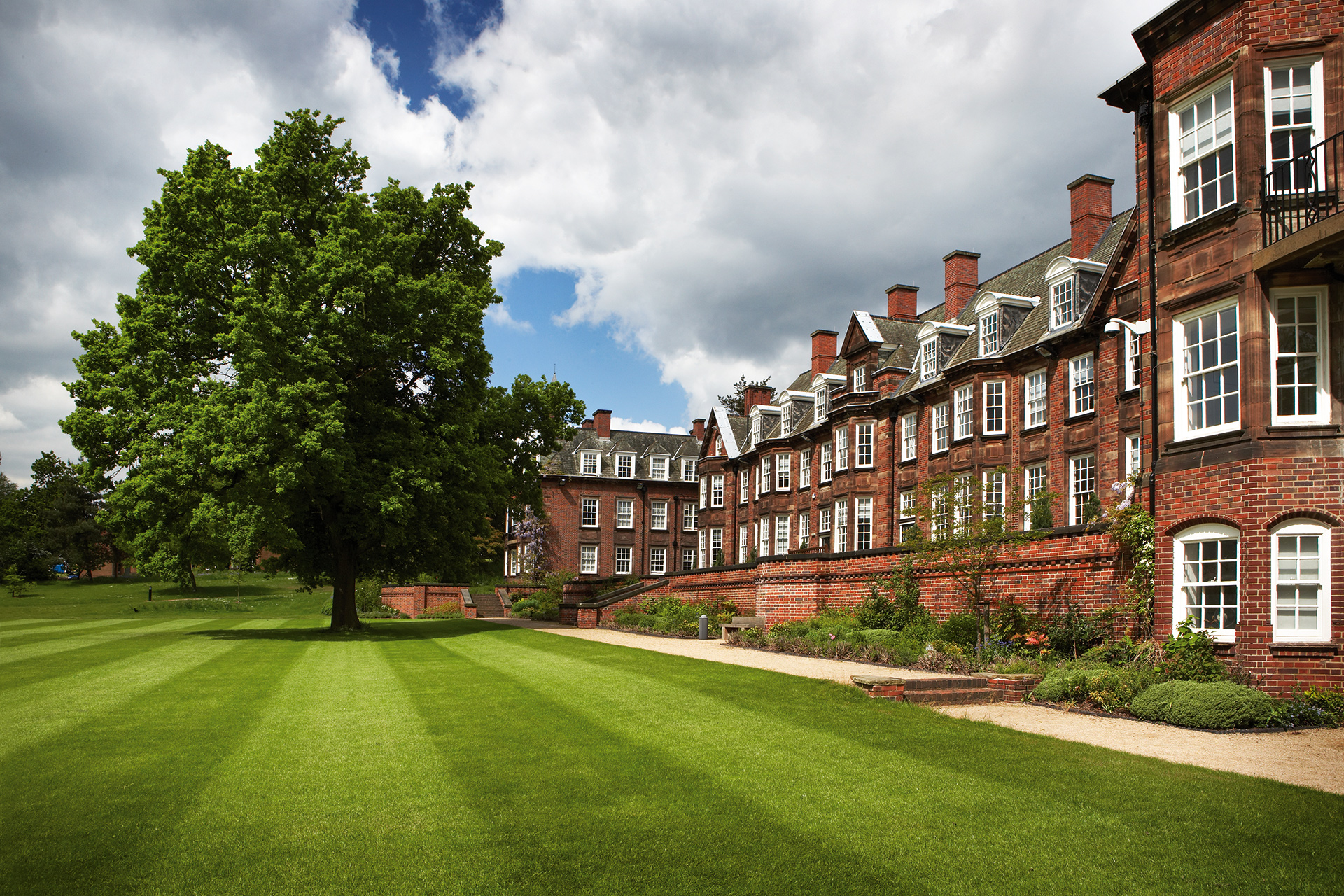 A view of Birmingham Business school from the back of the building across the lawn