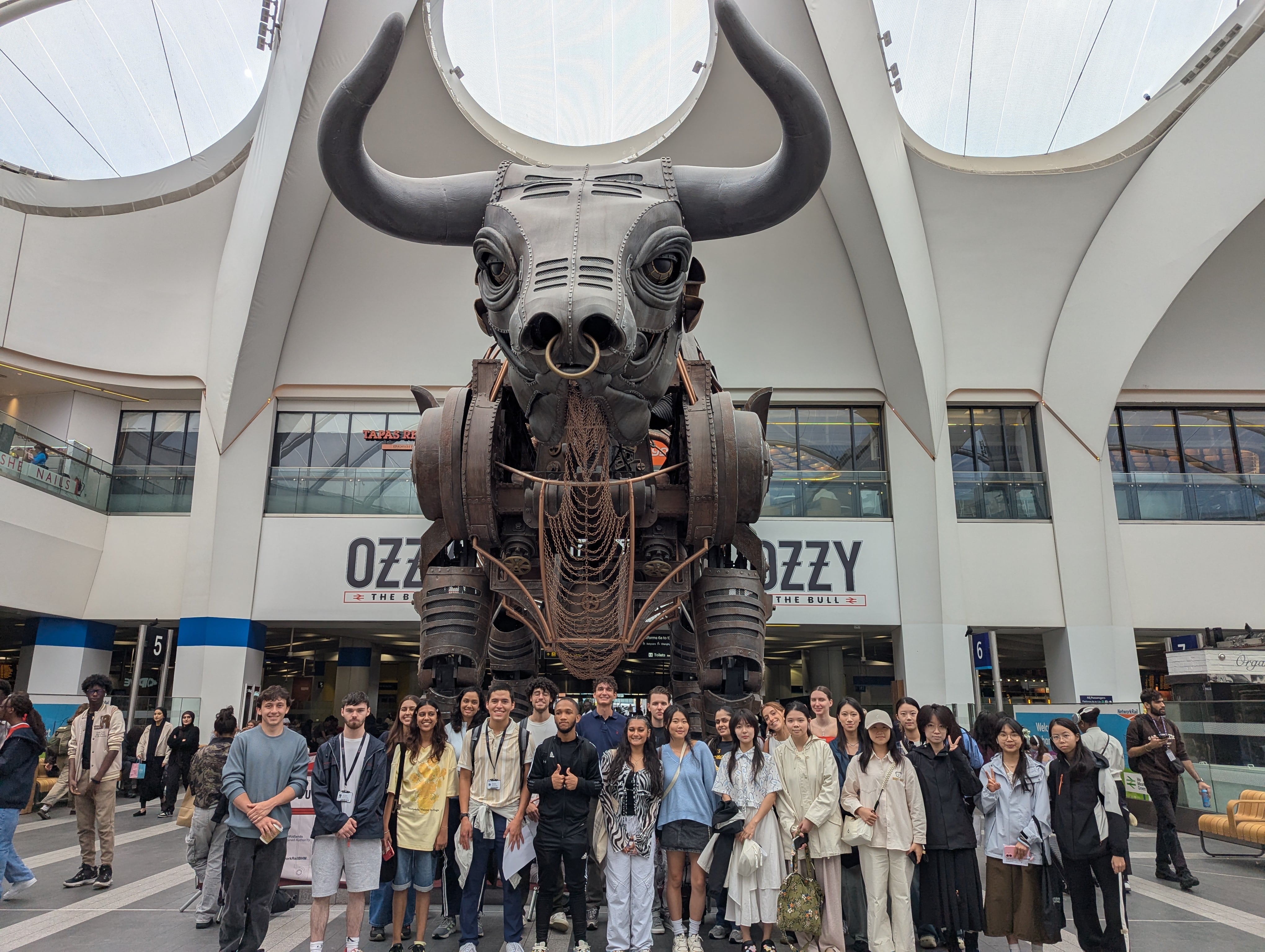 Summer school students posing with Ozzy the Bull of Birmingham city