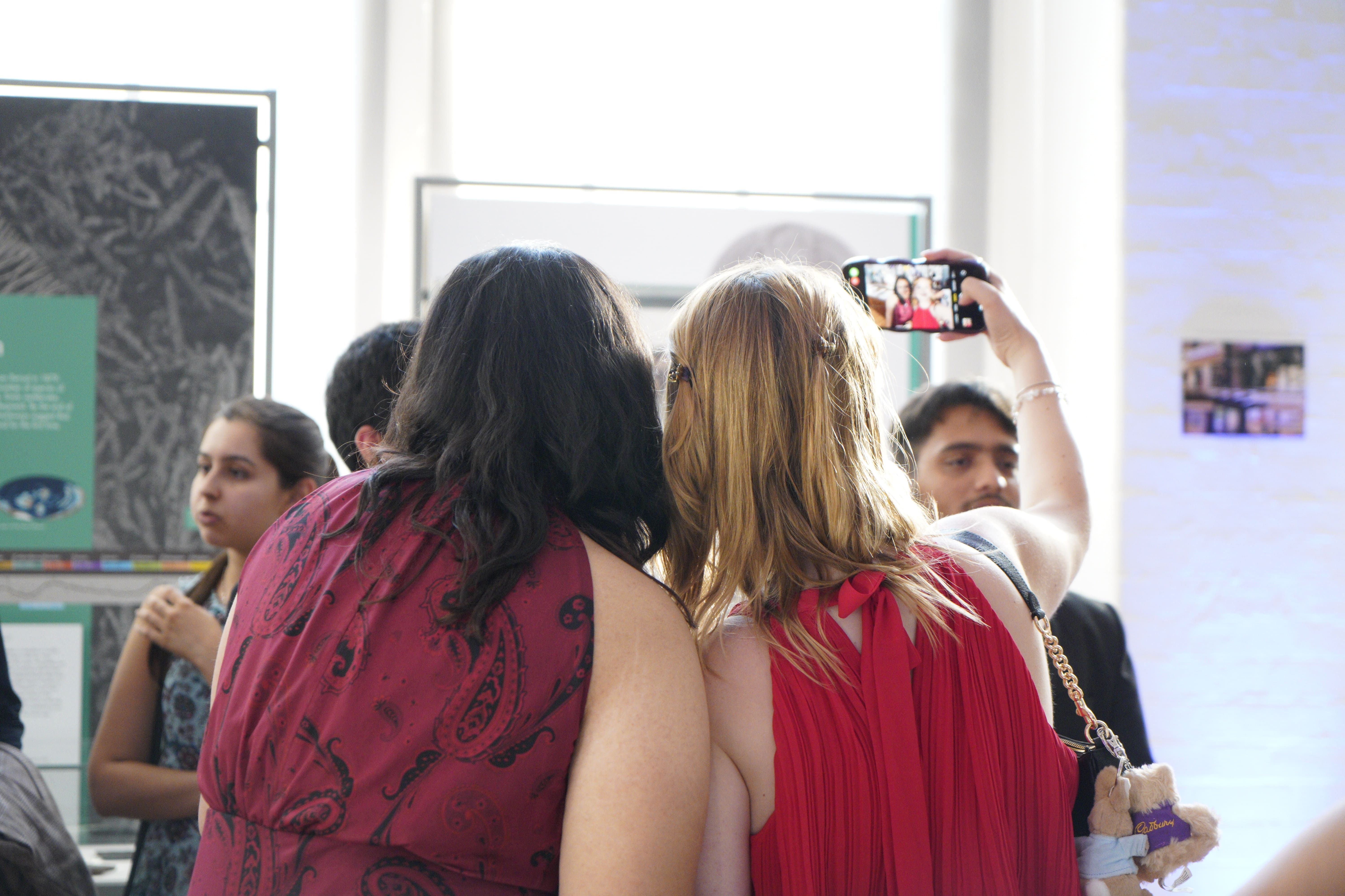 back of two summer school students who are clicking a selfie