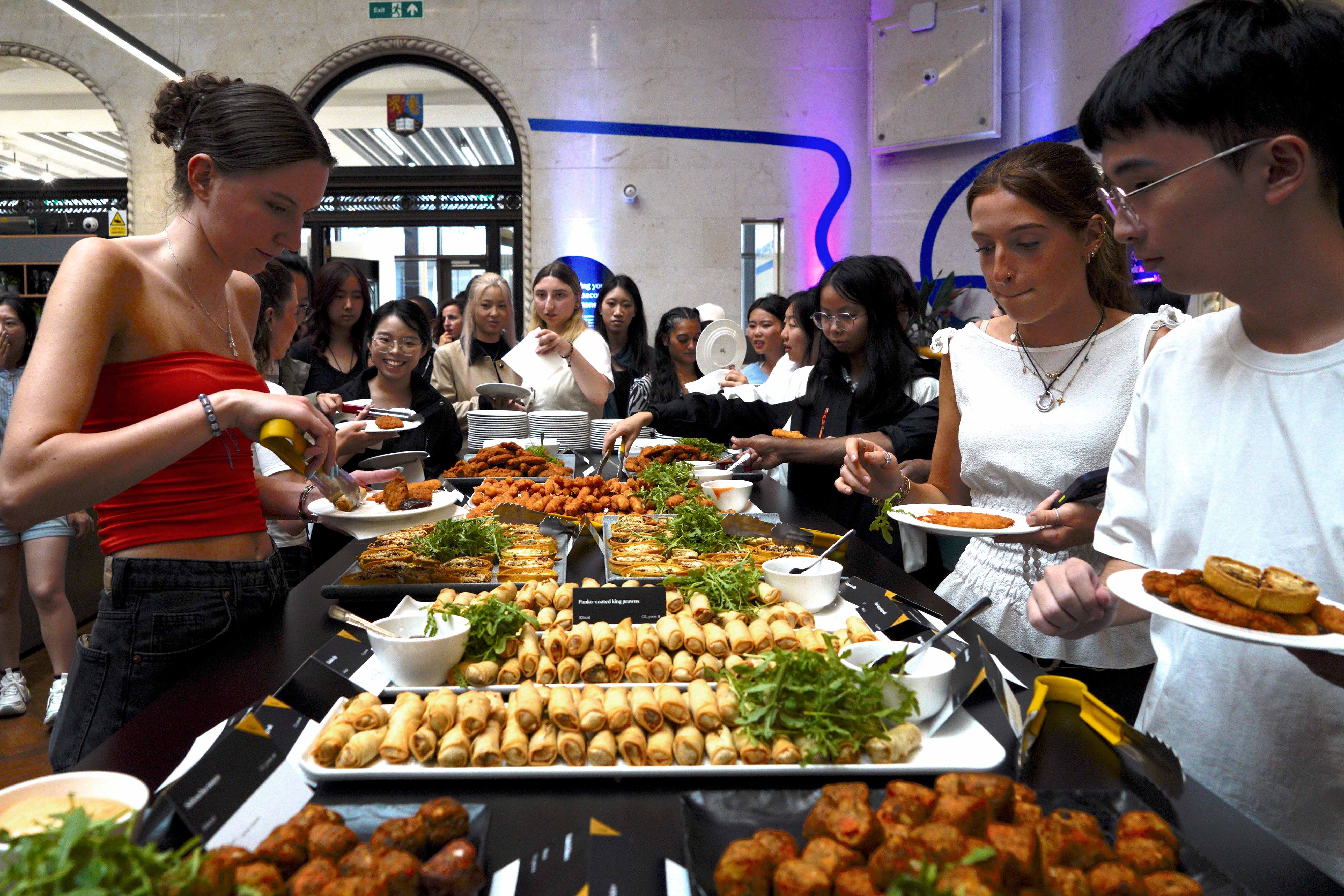 Summer school students filling their plate with various finger foods