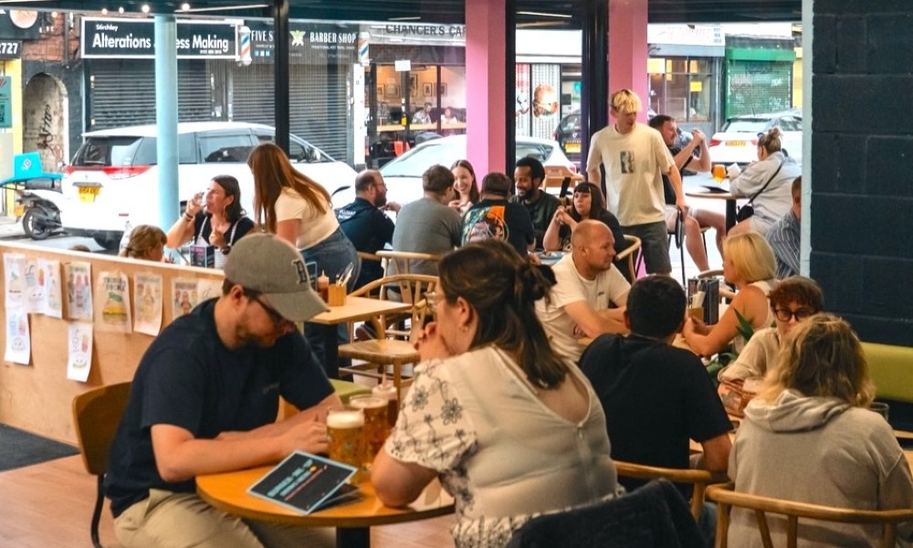 The inside of a burger restaurant with people eating at tables