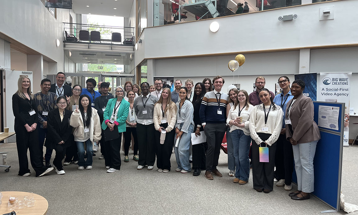 A group photo of students and visitors to the showcase