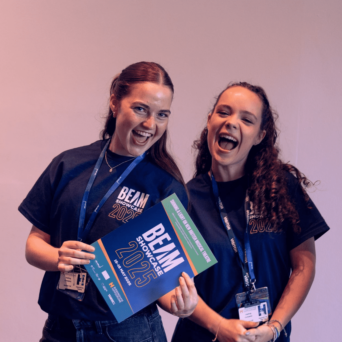 Two people holding a show programme