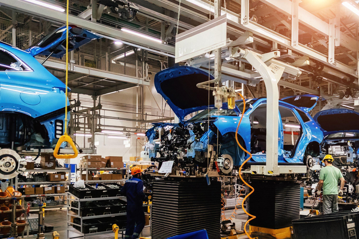 Car chassis moving along a car production line