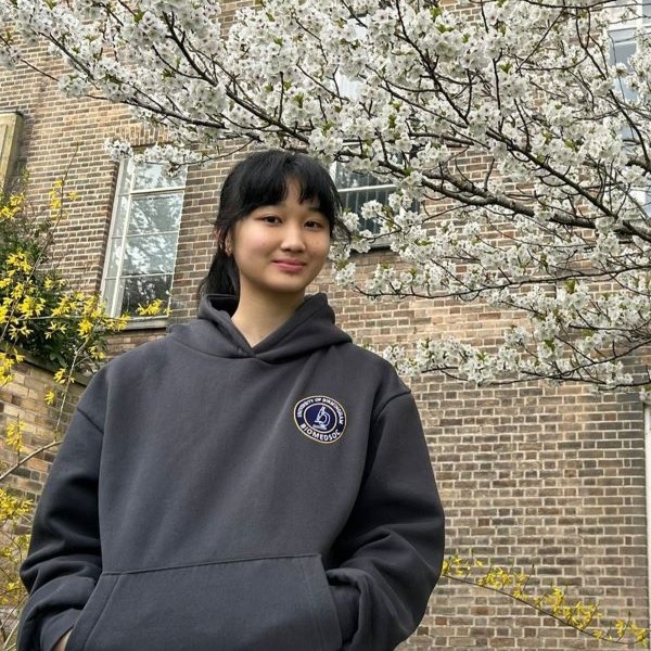Biomedical Science student, Charlotte Wong smiling outside Medical School in autumn