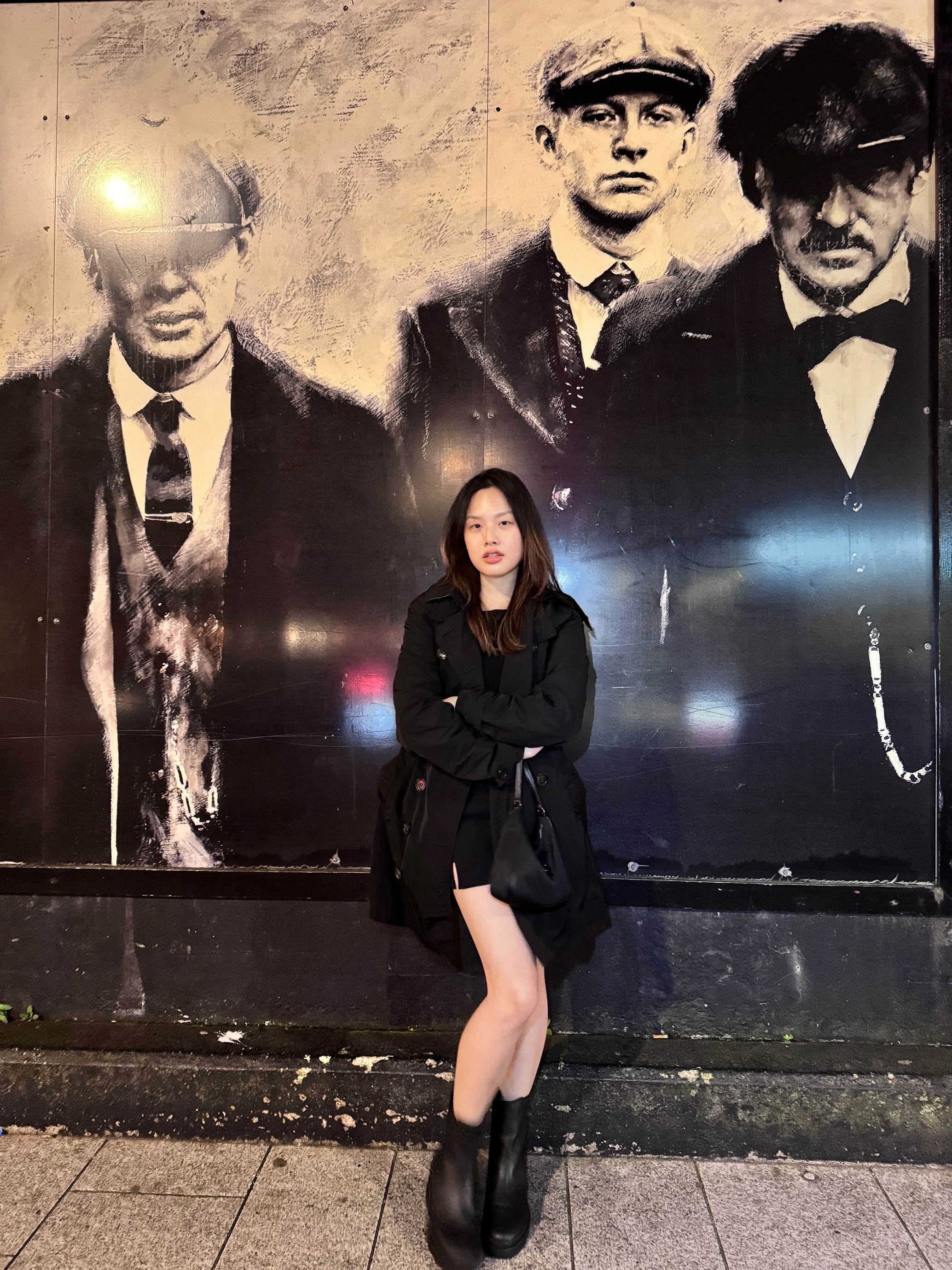 Student Chloe is standing in front of some street art.