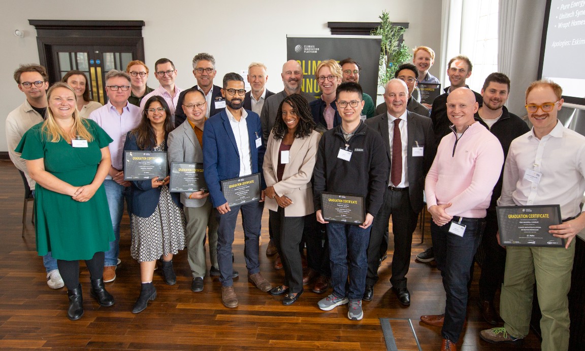 A group of 23 people standing holding certificates